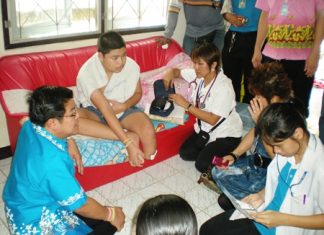 Deputy Mayor Verawat Khakhay (left) and Sub Lt. Supatra Ngamyanglai (right) discuss options with patient Supachai Komolthiti.
